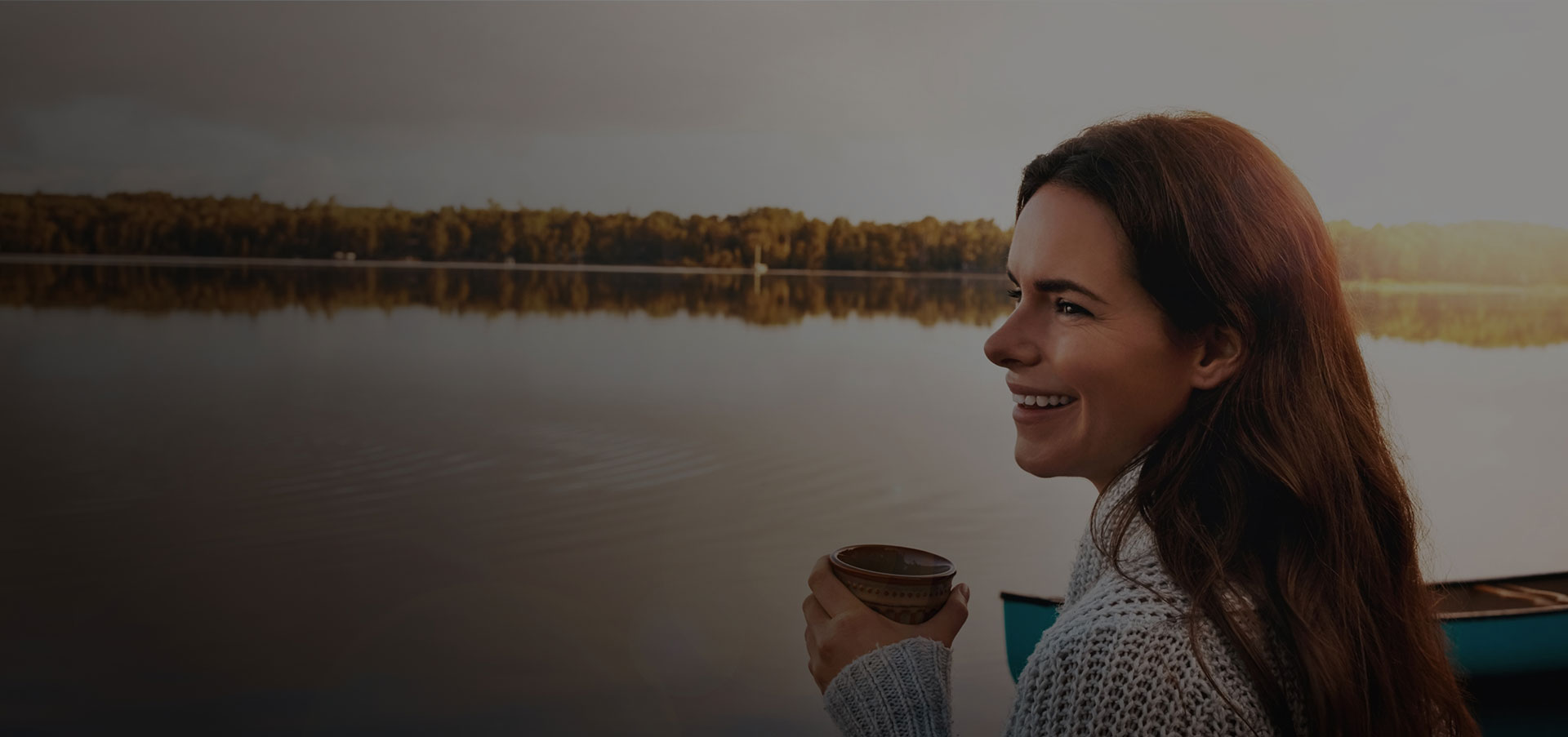 Lady having coffee cup on lake side